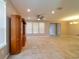 Spacious living room featuring tile flooring, a ceiling fan, and ample natural light at 3651 Nw 56Th Ave, Ocala, FL 34482