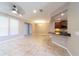 Open-concept living area with tile flooring, leading into the kitchen with a breakfast bar at 3651 Nw 56Th Ave, Ocala, FL 34482