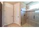 Tiled shower with glass door and seating, complemented by two white doors for easy access at 3651 Nw 56Th Ave, Ocala, FL 34482