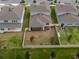 Aerial view of a fenced backyard with a screened-in lanai and minimal landscaping at 4007 Meandering Bay Dr, Apopka, FL 32712