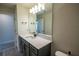 Bathroom featuring a large mirror, vanity with gray cabinets, and wood-look flooring at 4007 Meandering Bay Dr, Apopka, FL 32712