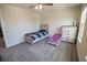 Bright bedroom features neutral walls, gray carpet, and two beds including one toddler-sized bed at 4007 Meandering Bay Dr, Apopka, FL 32712
