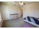 Bedroom with neutral walls, gray carpet, ceiling fan, and light wood dresser with six drawers at 4007 Meandering Bay Dr, Apopka, FL 32712