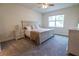 Bright bedroom featuring a queen bed, a window, and nightstands with lamps at 4007 Meandering Bay Dr, Apopka, FL 32712