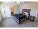 Bedroom with neutral walls, carpet, wood bed frame, and a full bathroom at 4007 Meandering Bay Dr, Apopka, FL 32712