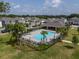 Aerial view of the community pool surrounded by patio furniture in a well-landscaped area at 4007 Meandering Bay Dr, Apopka, FL 32712