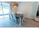 Dining room features wood-style flooring, modern lighting fixture and a dining table that seats six at 4007 Meandering Bay Dr, Apopka, FL 32712