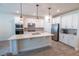 Bright kitchen with white cabinetry, stainless steel appliances, and a large center island with a sink at 4007 Meandering Bay Dr, Apopka, FL 32712