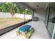 Backyard patio with blue picnic table, stainless steel grill, and tree in the fenced yard at 4007 Meandering Bay Dr, Apopka, FL 32712
