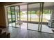 View from indoor patio out into yard with glass sliding doors, tile floors, and picnic table at 4007 Meandering Bay Dr, Apopka, FL 32712