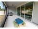 Covered outdoor patio with tile floor, blue picnic table and stainless steel grill at 4007 Meandering Bay Dr, Apopka, FL 32712