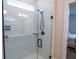 Beautifully tiled glass-enclosed shower with matte black fixtures at 4007 Meandering Bay Dr, Apopka, FL 32712