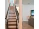 Open wood staircase with modern wrought iron railing at 4007 Meandering Bay Dr, Apopka, FL 32712