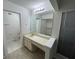 Bathroom featuring a spacious countertop vanity, large mirror, and an adjoining toilet room with a walk-in closet at 4372 Middlebrook Rd # 3, Orlando, FL 32811
