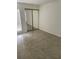 Bright bedroom featuring mirror sliding closet doors and tile flooring, providing ample space at 4372 Middlebrook Rd # 3, Orlando, FL 32811