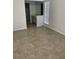 Bedroom featuring tile floors, a window with blinds, and a view into the bathroom at 4372 Middlebrook Rd # 3, Orlando, FL 32811