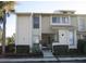 Exterior shot showing the multi-level townhome with neutral tones and manicured landscaping for a welcoming aesthetic at 4372 Middlebrook Rd # 3, Orlando, FL 32811