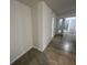 Hallway featuring ceramic tile flooring with a view of a mirrored closet, and an exit to the exterior at 4372 Middlebrook Rd # 3, Orlando, FL 32811