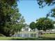 Picturesque view of the community pond with lush green trees providing a serene and natural environment at 4372 Middlebrook Rd # 3, Orlando, FL 32811
