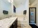 Bright bathroom with granite vanity, large mirror, tub/shower, and tile floors at 4900 Beach Blvd, Orlando, FL 32803