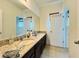 Bathroom featuring an oversized granite-topped vanity with ample counterspace and storage at 4900 Beach Blvd, Orlando, FL 32803