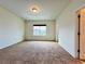 Bright bedroom with multiple doors, carpeted floor, and a view from the window at 4900 Beach Blvd, Orlando, FL 32803