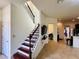 Bright entryway featuring tile floors, staircase, and modern recessed lighting at 4900 Beach Blvd, Orlando, FL 32803