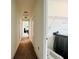 Hallway leading to a laundry room with a visible black washer and dryer at 4900 Beach Blvd, Orlando, FL 32803