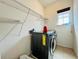 Laundry room equipped with storage shelves, a window, and a modern washer and dryer at 4900 Beach Blvd, Orlando, FL 32803