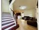 Open-concept living space with tiled floors, staircase and dark cabinets at 4900 Beach Blvd, Orlando, FL 32803