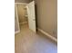 Bedroom featuring an open closet with shelves and neutral tile flooring at 5116 Conroy Rd # 411, Orlando, FL 32811