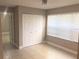 Bedroom with tile flooring, neutral walls, and window with blinds at 5116 Conroy Rd # 411, Orlando, FL 32811