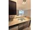 Kitchen island with stainless steel sink, granite countertops, and ample lighting at 5116 Conroy Rd # 411, Orlando, FL 32811