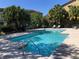 Inviting community pool surrounded by lush landscaping, lounge chairs, and mature trees at 5116 Conroy Rd # 411, Orlando, FL 32811