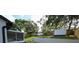 A spacious backyard featuring a new fence, screened in porch and large trees at 5118 Log Wagon Rd, Ocoee, FL 34761