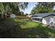 A spacious backyard featuring a new fence, screened in porch and large trees at 5118 Log Wagon Rd, Ocoee, FL 34761