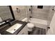 Stylish bathroom features a shower-tub combo, modern fixtures, and elegant tile work at 5118 Log Wagon Rd, Ocoee, FL 34761