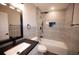 Modern bathroom with a bathtub, tiled walls, black hardware, and a stylish vanity with a black countertop at 5118 Log Wagon Rd, Ocoee, FL 34761