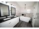 Elegant bathroom boasts a double sink vanity, soaking tub, and chic chandelier at 5118 Log Wagon Rd, Ocoee, FL 34761
