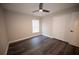 Cozy bedroom featuring a ceiling fan and dark wood-look flooring, adding a modern touch at 5118 Log Wagon Rd, Ocoee, FL 34761