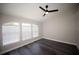 Airy bedroom features vaulted ceiling, three large windows, and dark wood-look flooring at 5118 Log Wagon Rd, Ocoee, FL 34761