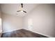 A bedroom with a ceiling fan, wood-look floors, and a white door at 5118 Log Wagon Rd, Ocoee, FL 34761