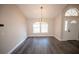 Bright dining room with large windows, modern lighting, and neutral paint color at 5118 Log Wagon Rd, Ocoee, FL 34761