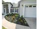Charming single-story home featuring a well-manicured lawn with fresh mulch at 5118 Log Wagon Rd, Ocoee, FL 34761