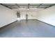 An empty garage with a gray floor, a water heater, and a door to the interior of the home at 5118 Log Wagon Rd, Ocoee, FL 34761