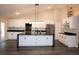 Spacious kitchen with black countertops, white cabinets, stainless steel appliances, and a large island at 5118 Log Wagon Rd, Ocoee, FL 34761