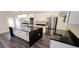 A spacious kitchen features a large island, stainless steel appliances, white cabinets, and modern finishes at 5118 Log Wagon Rd, Ocoee, FL 34761