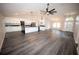 Open-concept living space with island kitchen and dark wood-look flooring, perfect for gatherings at 5118 Log Wagon Rd, Ocoee, FL 34761