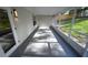A screened in patio with gray floors and a view of the backyard at 5118 Log Wagon Rd, Ocoee, FL 34761
