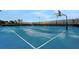 Full-size basketball court with pristine blue surface and clearly marked lines, great for sports at 720 Gardenia Ln, Davenport, FL 33897